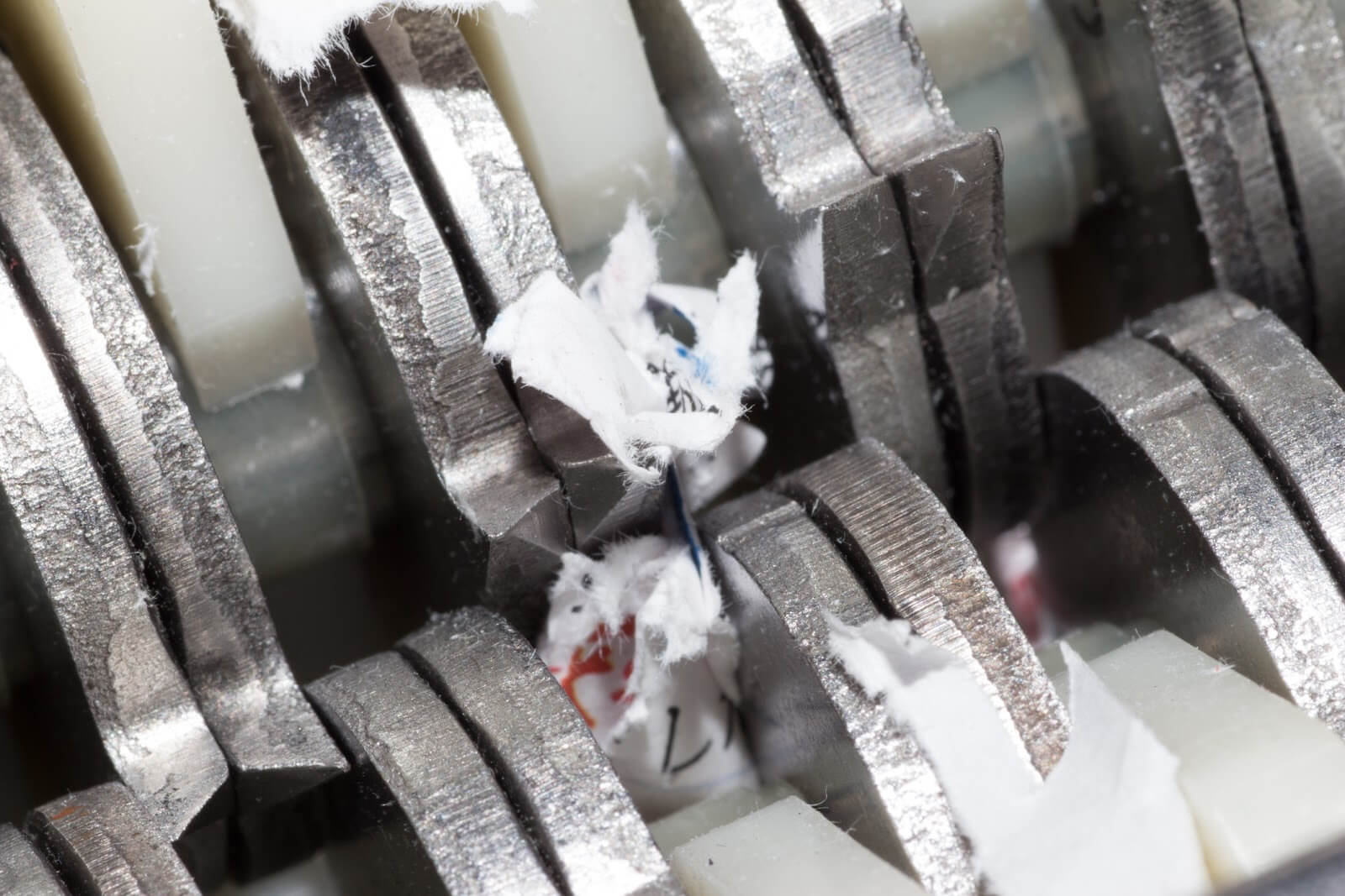 Jammed shredder scraps between paper shredder blades