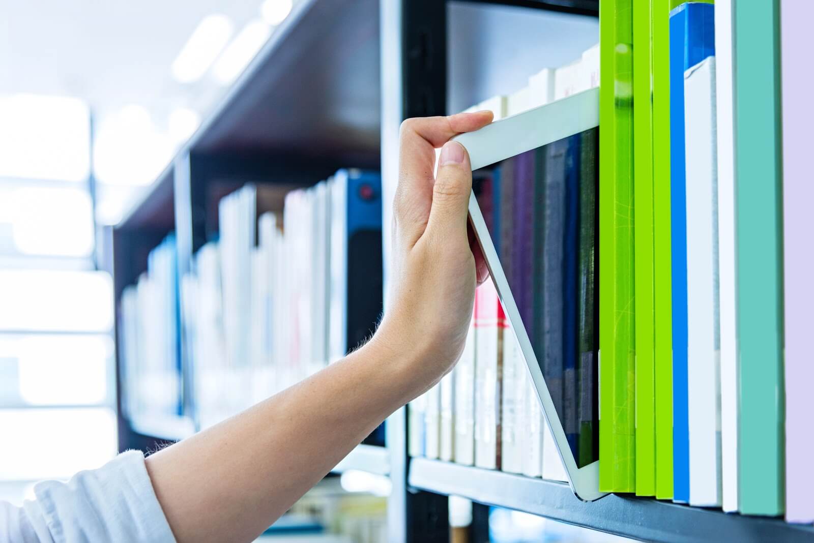 a person taking out a patient file from a shelf