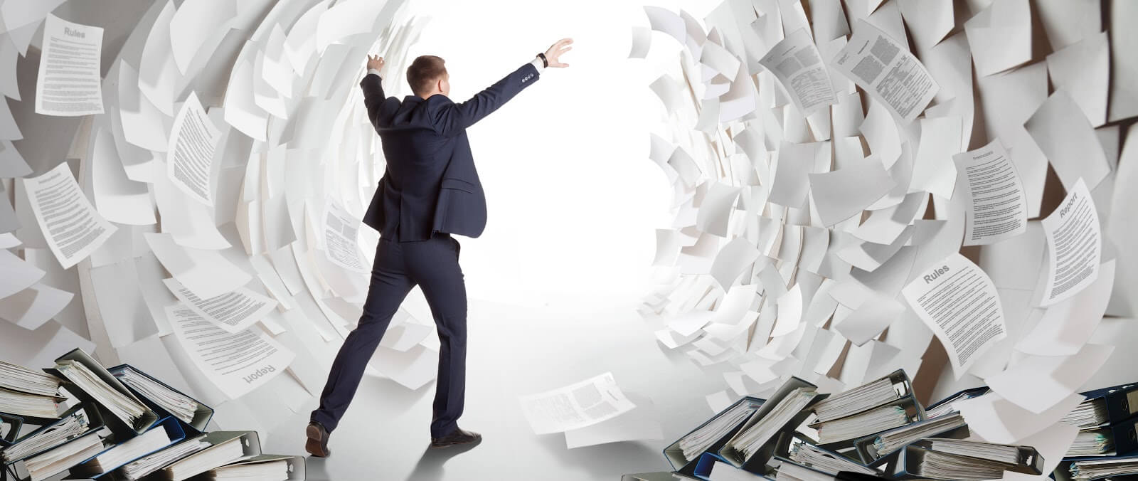 Office worker creates a passage in a paper Sea as Moses. 