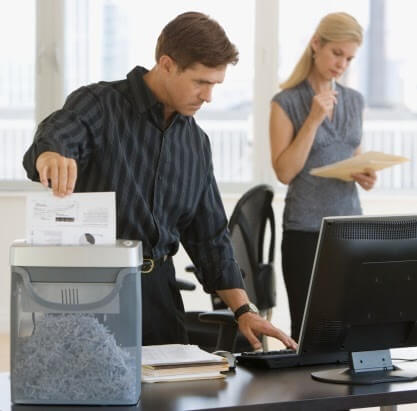 Businessman shredding paperwork