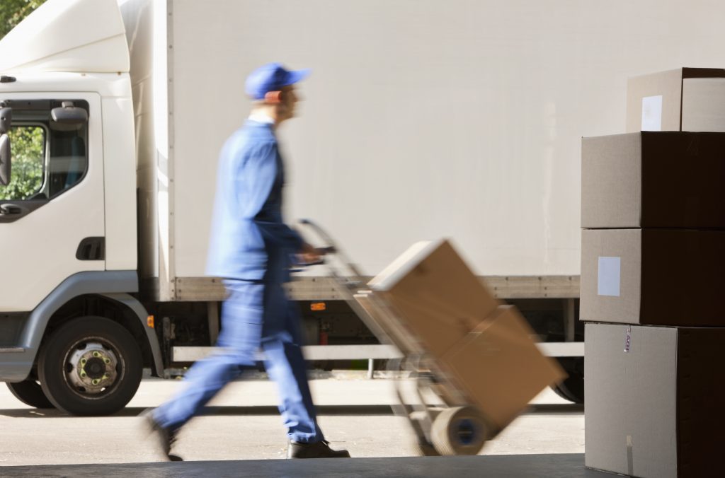 Mobile shredding truck employee transporting boxes of documents