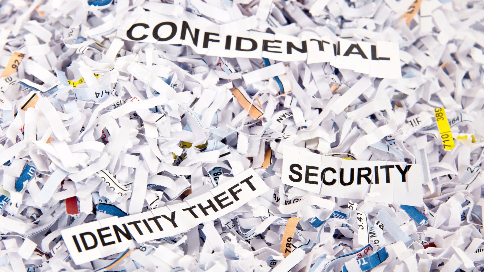 a pile of shredded paper with the words "confidential, identity theft and security"
