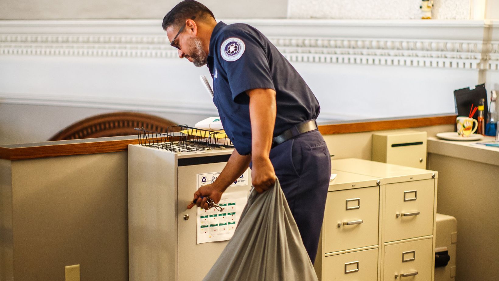 shredding expert taking documents from secure container